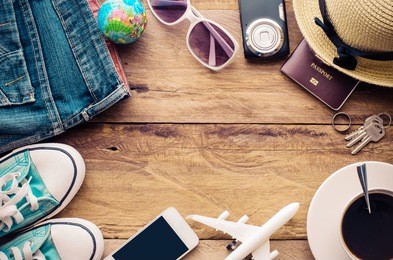 tourism planning and equipment needed for the trip on wooden floor