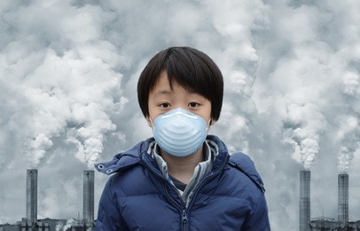 asian boy wearing mouth mask against air pollution