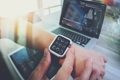 website designer working with smart watch and digital tablet and digital design diagram on wooden desk as concept