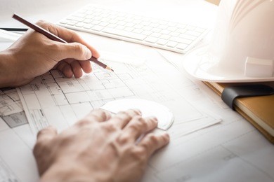 top view of architect drawing on architectural project,projecting with pencil on the urban drawings. home planning,architectural plans.