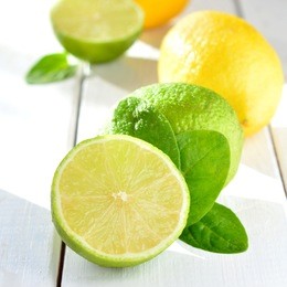 citruses - lemon and lime on white table close up