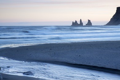 reynisdrangar sea stacks at sunset, vik, iceland, with black sand beach in foreground