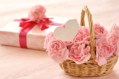pink carnation and gift box with white heart paper
