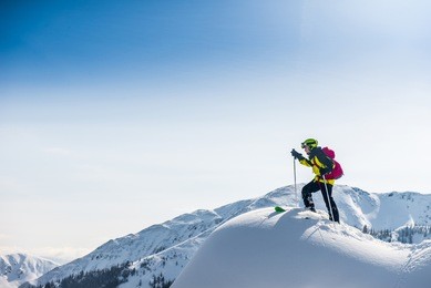 skier walking on top of the mountain.