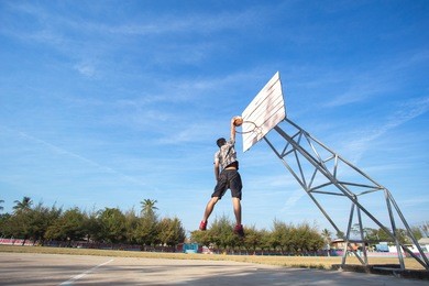 basketball street player making  slam dunk