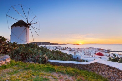 traditional windmill over the town of mykonos, greece.
