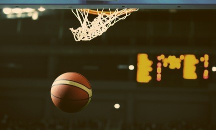 basketball going through the hoop at a sports arena (intentional spotlight)