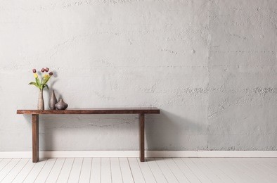 grey concrete wall wooden modern desk with wooden floor
