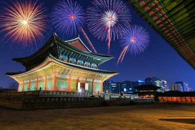 traditional motifs of gyeongbokgung palace and fireworks at night in seoul, south korea.