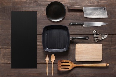 various kitchenware utensils on the wooden background.