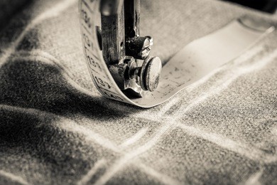 vintage tailor machine with scissors, cloth and threads