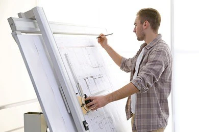 male architects working on blueprints