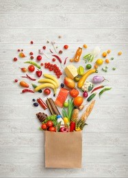 healthy food in package. studio photography of different fruits and vegetables on white wooden background, top view. high resolution product.