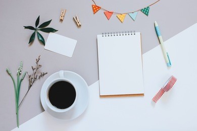 creative flat lay photo of cute workspace desk with notebook, coffee, name card and decorated cute craft with copy space background, minimal style
