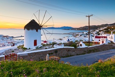 traditional windmill over the town of mykonos, greece.