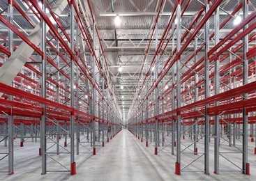  industrial racks pallets shelves in huge empty warehouse interior.  storage equipment.