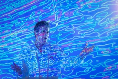 male scientist making presentation with graphical geological data projection