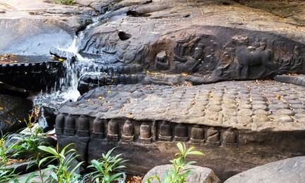 carving is god shiva riding on a bull with his consort uma. cambodia, phnom kulen linga river