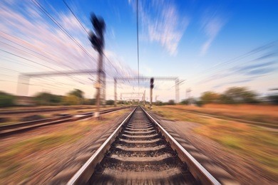 railway station at colorful sunset with motion blur effect. railroad in ukraine. 
