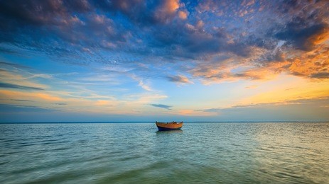 lonely boat on the baltic sea at sunset. hdr - high dynamic range