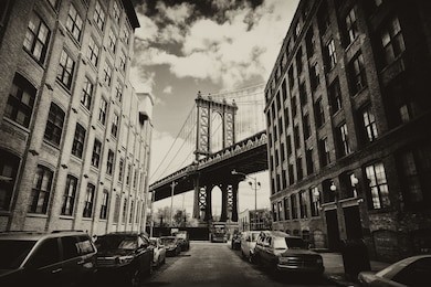 manhattan bridge seen from a brick buildings in brooklyn street in perspective, new york, usa. business and travel background. vintage, retro postcard with sepia filter.