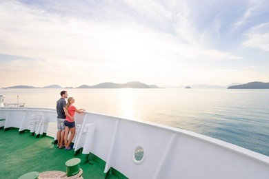 romantic vacation. young loving couple enjoying sunset on cruise ship deck. sailing the sea.