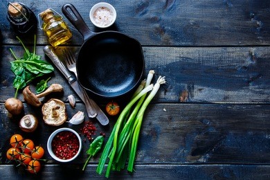 top view of colorful organic vegetables and seasoning ingredients on rustic kitchen table with olive oil and balsamic vinegar. healthy food or vegetarian food concept.