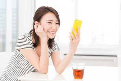 young attractive asian woman  to see a smart phone