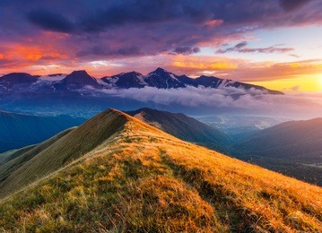 a great view of the hills glowing by sunlight at twilight. dramatic and picturesque morning scene. artistic picture. beauty world. warm toning effect. creative collage. soft filter effect.