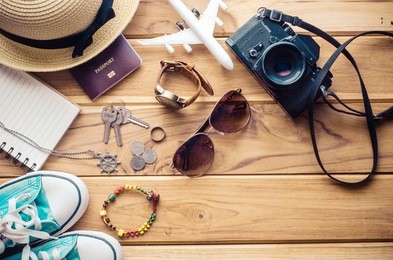 tourism planning and equipment needed for the trip on wooden floor
