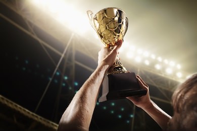 athlete holding trophy cup