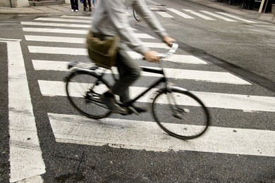traffic with speedy cyclist passing crosswalk.