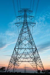 electricity transmission power lines at sunset (high voltage tower)