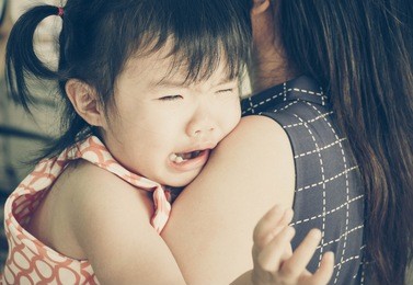 asian baby girl hugging her mother crying