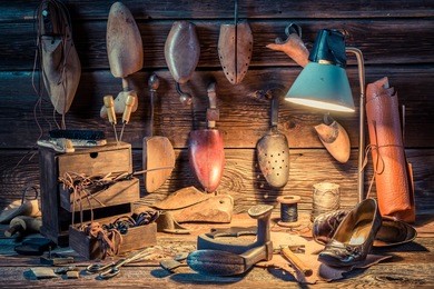 shoemaker workshop with tools, shoes and laces