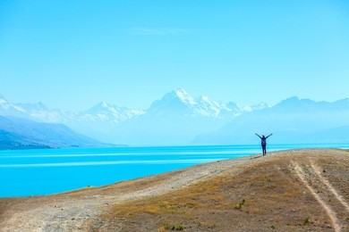 asian woman travel enjoy at lake pukaki as a mt. cook background , new zealand