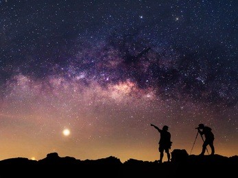 star-catcher. a person is standing next to the milky way galaxy. elements of this image furnished by nasa.
