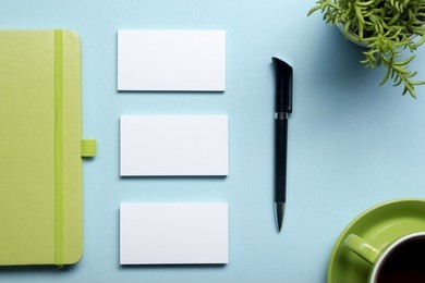 business card blank, notepad, flower, coffee cup and pen at office desk table top view. corporate stationery branding mock-up
