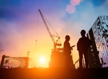 silhouette young engineer working construction standards in line with global  and the environment around the work site. over blurred worker on industry site