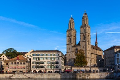beautiful view of zurich old town with grossmunster church and limmat river at dusk, zurich, switzerland.