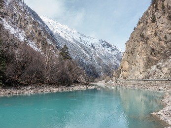 the brahmaputra cross through the tibetan plateau snow mountain in bomi, tibet china.