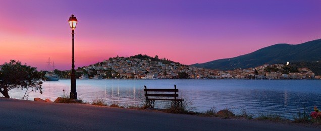 'aegean relief': sunrise panorama in warm colours of poros town, greece