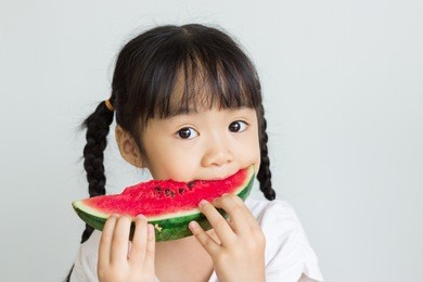 asian child eat watermelon
