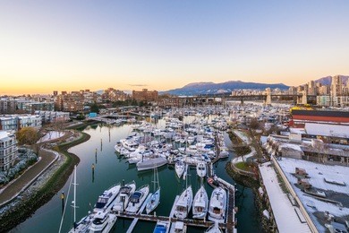 snowy view from the granville bridge onto the granville island. downtown skyline in vancouver, canada.
