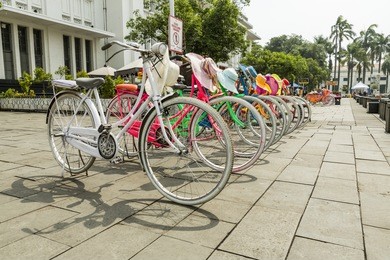 colorful bicycles lined up on fatahilah square in jakarta's old town. 