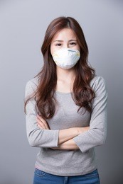 a woman wears a mask and cross arms, illness, asian beauty