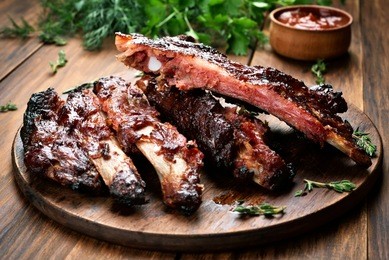 roasted sliced barbecue pork ribs, focus on sliced meat.