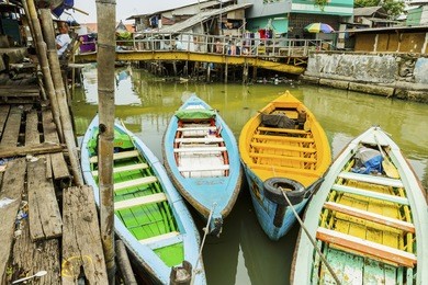 sunda kelapa old harbour with fishing boats, ship and docks in jakarta, indonesia.