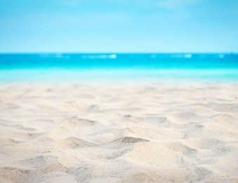 close up sand with blurred sea sky background, summer day, copy space or for product.