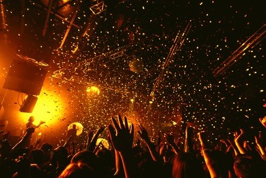 night party festival crowd of people silhouettes hands up with confetti